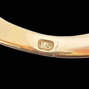 Antique 15ct Yellow Gold Garnet Solitaire Dress Ring close-up of the 15 stamp inside the shank, on a black background