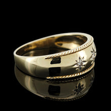 Load image into Gallery viewer, A three stone diamond star set gypsy ring in yellow gold, on a black background

