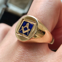 Load image into Gallery viewer, A yellow gold signet ring with an enamelled Masonic square, modelled on a hand
