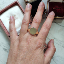 Load image into Gallery viewer, A yellow gold plain oval signet ring, modelled on a hand
