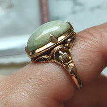 Load image into Gallery viewer, An oval, cabochon green agate dress ring in yellow gold, modelled on a hand
