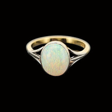 Load image into Gallery viewer, Gold ring with a central opal stone on a black background
