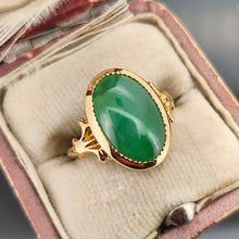Load image into Gallery viewer, An oval shaped green jade ring in yellow gold, in an antique ring box
