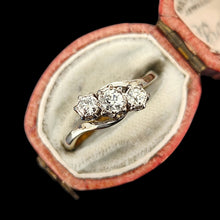 Load image into Gallery viewer, A three stone diamond trilogy ring in yellow gold and platinum, in a ring box, on a black background
