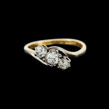 Load image into Gallery viewer, A three stone diamond trilogy ring in yellow gold and platinum, on a black background
