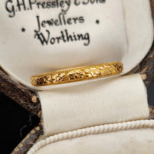 Load image into Gallery viewer, A yellow gold floral patterned wedding band ring, in an antique ring box
