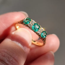 Load image into Gallery viewer, Vintage 18ct Gold Emerald and Diamond Carved Half Hoop Ring in hand
