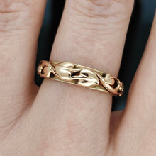 Load image into Gallery viewer, A yellow gold leaf motif band ring, modelled on a hand
