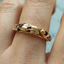 Load image into Gallery viewer, A yellow gold leaf motif band ring, modelled on a hand
