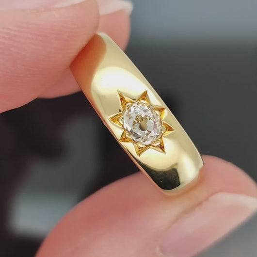 Video of an yellow gold gypsy set old cut diamond ring, held in a hand