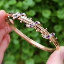 Load image into Gallery viewer, Antique 9ct Gold Amethyst &amp; Seed Pearl Bangle in hand
