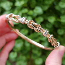 Load image into Gallery viewer, 9ct Yellow &amp; White Gold Knot Bangle in hand
