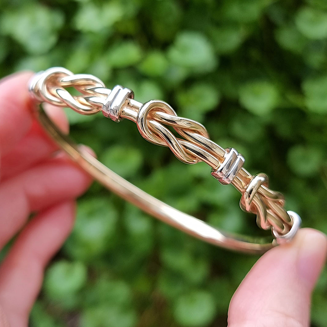 9ct Yellow & White Gold Knot Bangle in hand