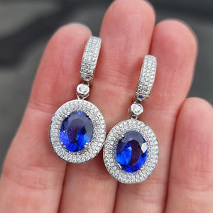 18ct White Gold Tanzanite and Diamond Cluster Drop Earrings in hand