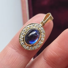 Load image into Gallery viewer, Vintage 18ct Gold Cabochon Sapphire &amp; Diamond Oval Pendant in hand
