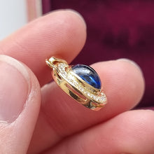 Load image into Gallery viewer, Vintage 18ct Gold Cabochon Sapphire &amp; Diamond Oval Pendant in hand
