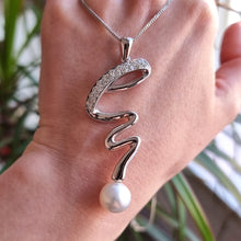 Load image into Gallery viewer, 18ct White Gold Pearl and Diamond Twist Pendant with Chain in hand
