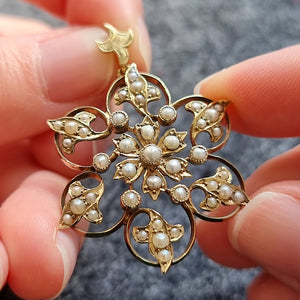 Antique 9ct Gold Seed Pearl Flower Pendant in hand