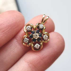 Vintage 18ct Gold Sapphire and Diamond Flower Pendant in hand