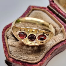 Load image into Gallery viewer, Vintage 18ct Gold Garnet &amp; Diamond Ring behind head
