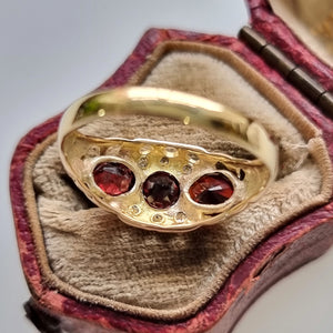 Vintage 18ct Gold Garnet & Diamond Ring behind head