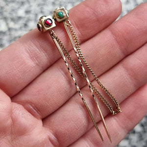 Antique Pair of 9ct Gold Turquoise & Garnet Stick Pins in hand